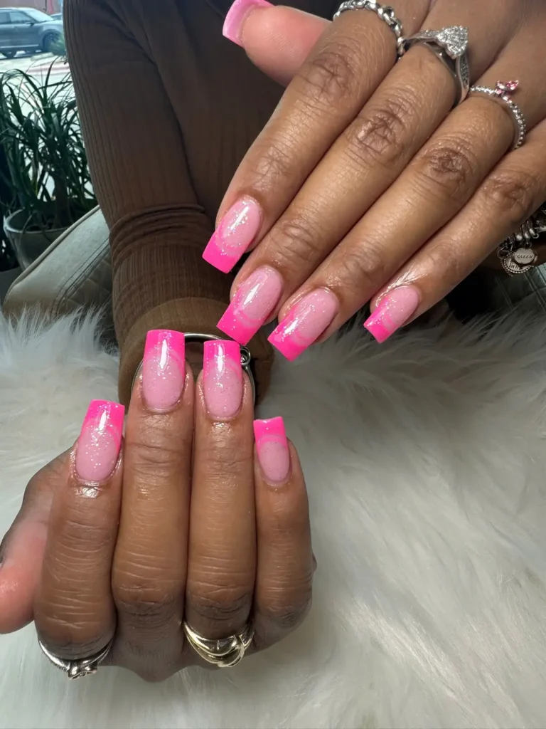 Long square nails with bright pink French tips and a shimmering pink base